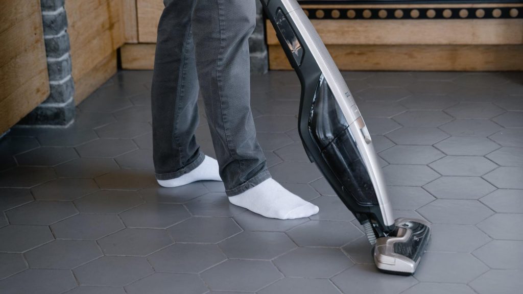 Are Cordless Vacuums Good? - Foot shot of someone cleaning with a cordless vacuum
