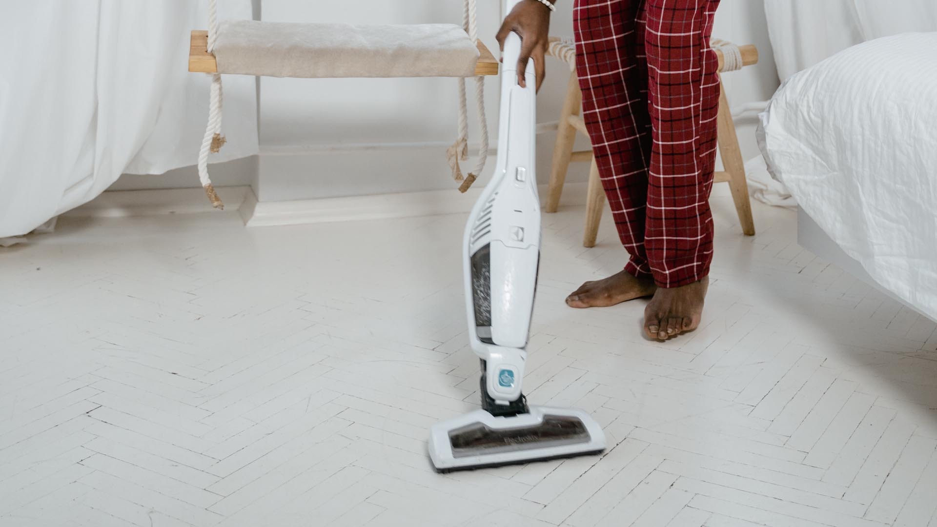 Are Stick Vacuums Better - vacuuming the bedroom