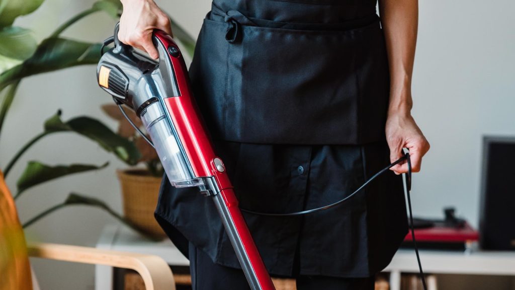 Are Stick Vacuums Better - Apron and Vacuum picture